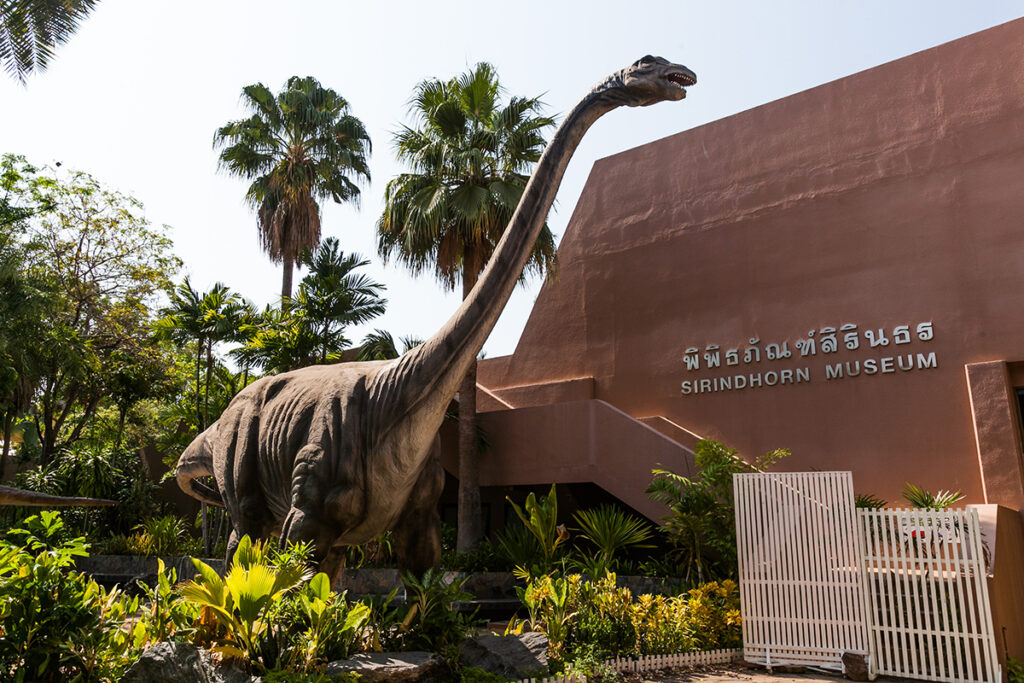 Large statue of Phuwiangosaurus outside the Sirindhorn Dinosaur Museum building in Kalasin, Thailand.