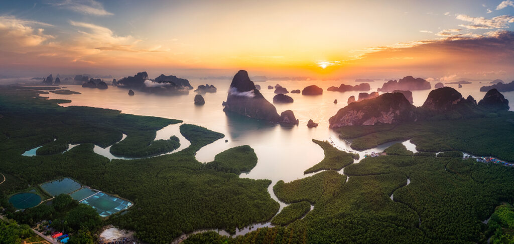 Limestone karst islands rising from emerald waters in Phang-Nga Bay as seen from the Samed Nang Chee View Point in Phang-Nga