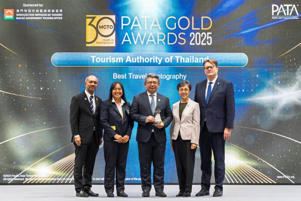 TAT executives receiving Best Travel Photography award on stage