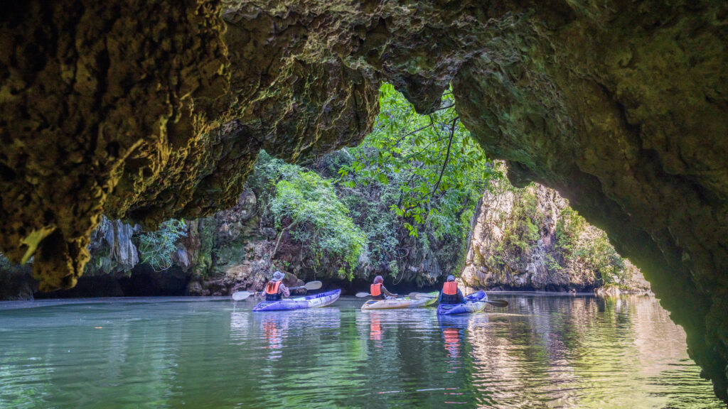 Kayaking through limestone caves at Ban Nai Nang Community, Krabi, highlighting eco-tourism and sustainable travel.