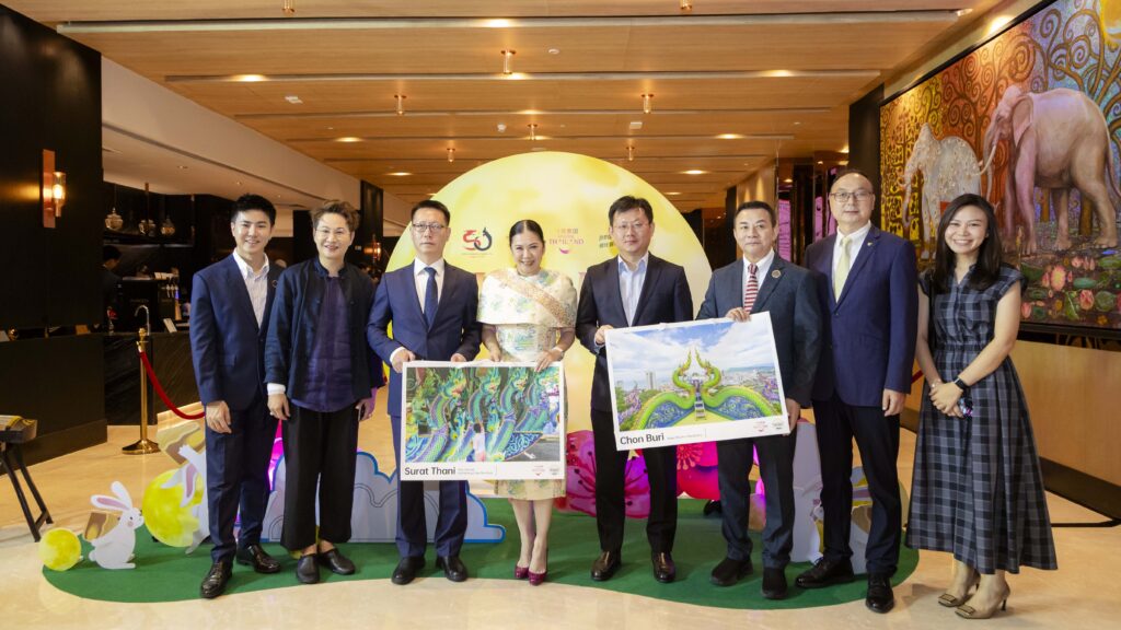 TAT executives and Chinese representatives at Nihao Month 2025 holding tourism posters