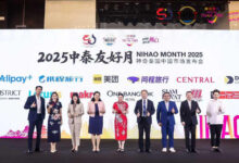 Group photo on stage Nihao Month Guangzhou 2025 with Thai and Chinese delegates and partner logos.