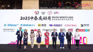 Group photo on stage Nihao Month Guangzhou 2025 with Thai and Chinese delegates and partner logos.
