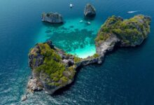 Aerial view of Ko Ha in Mu Ko Lanta National Park, Krabi, showcasing turquoise waters, coral reefs, and limestone islands within a protected marine area.