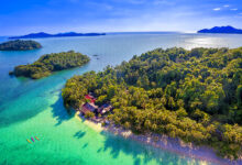 Vibrant aerial view of Ko Laoya’s lush greenery and clear turquoise waters in Trat, perfect for kayaking and island escapes.