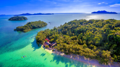 Vibrant aerial view of Ko Laoya’s lush greenery and clear turquoise waters in Trat, perfect for kayaking and island escapes.
