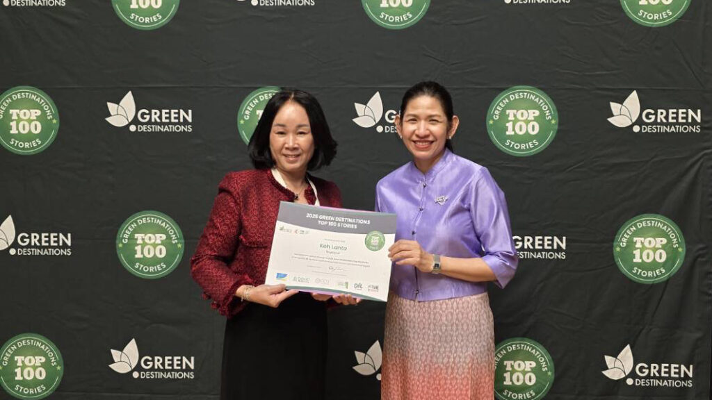 TAT representatives hold the 2025 Green Destinations Top 100 Stories certificate for Koh Lanta at the award ceremony backdrop in France.