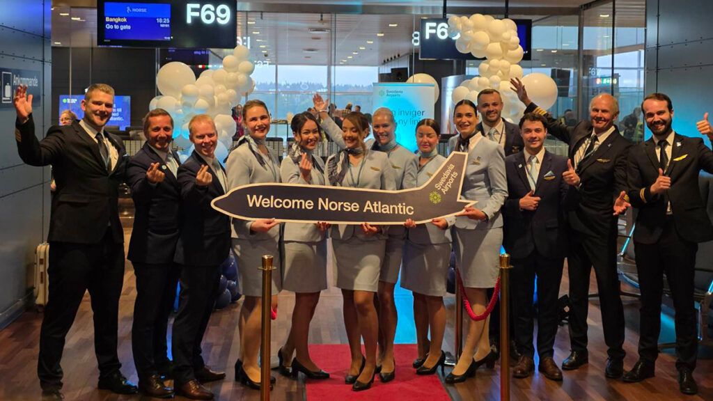 Norse Atlantic Airways cabin crew at Stockholm Arlanda Airport welcoming passengers on the inaugural Stockholm–Bangkok flight.