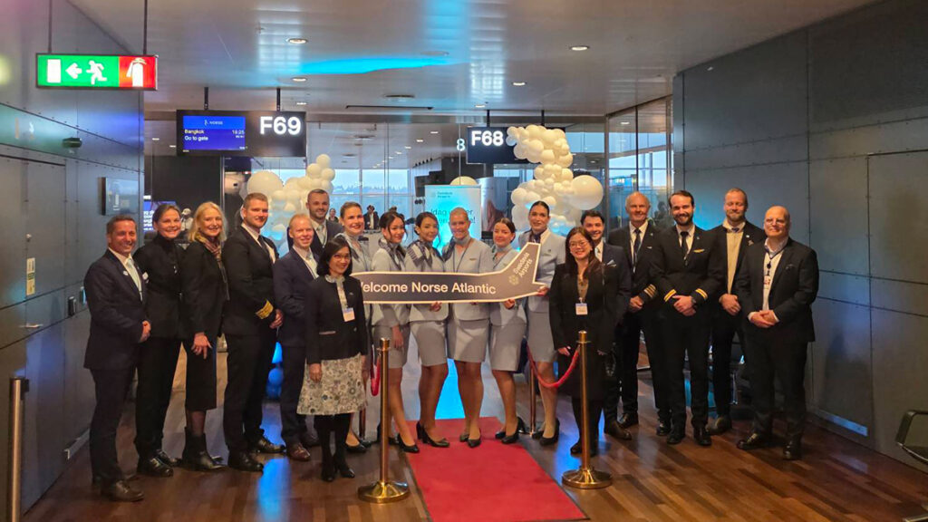 Group photo of Norse Atlantic Airways crew and representatives from Swedavia and TAT at Stockholm Arlanda Airport gate F69.