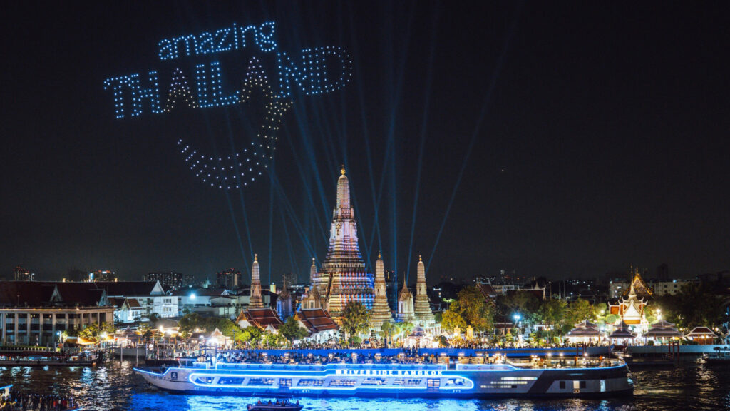 Drones form the “Amazing Thailand” logo in the night sky over Wat Arun during a riverside celebration.