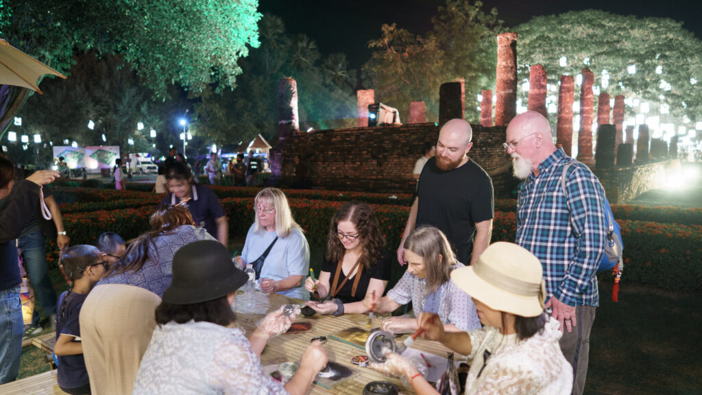 Thai and international visitors participate in traditional craft-making activities during the Loi Krathong event.