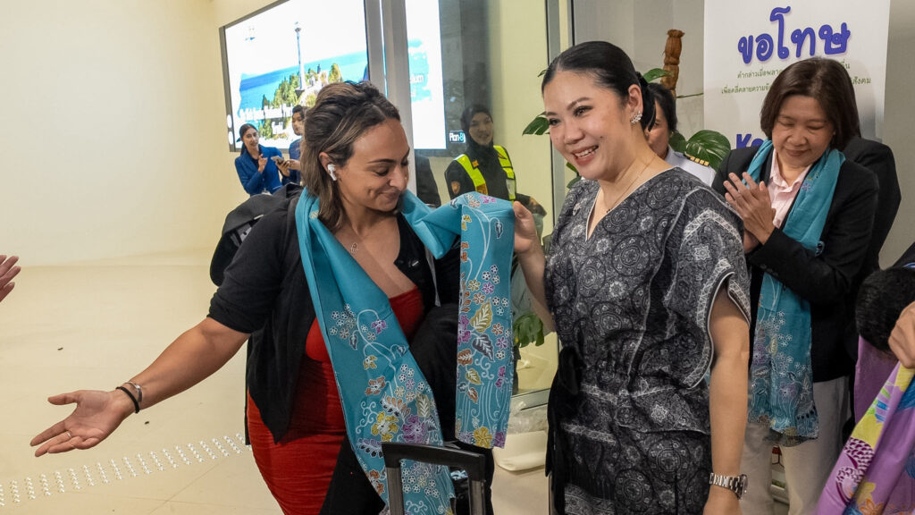 TAT Governor greets arriving passenger with a welcome scarf during the inaugural Etihad Airways Abu Dhabi–Krabi flight reception.