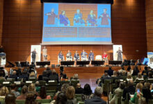Panel discussion at WSAT 2025 in Turin, Italy, featuring global tourism leaders on stage with sign language interpreters and accessibility subtitles.