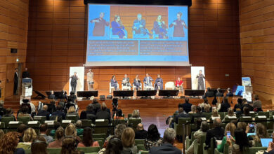 Panel discussion at WSAT 2025 in Turin, Italy, featuring global tourism leaders on stage with sign language interpreters and accessibility subtitles.