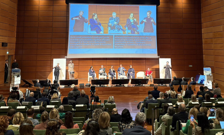 Panel discussion at WSAT 2025 in Turin, Italy, featuring global tourism leaders on stage with sign language interpreters and accessibility subtitles.
