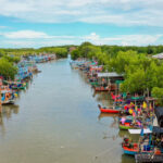 Colourful fishing boats line the canal at Laem Phak Bia community, reflecting Phetchaburi’s rich coastal lifestyle and sustainable tourism efforts.