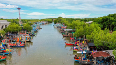 Colourful fishing boats line the canal at Laem Phak Bia community, reflecting Phetchaburi’s rich coastal lifestyle and sustainable tourism efforts.