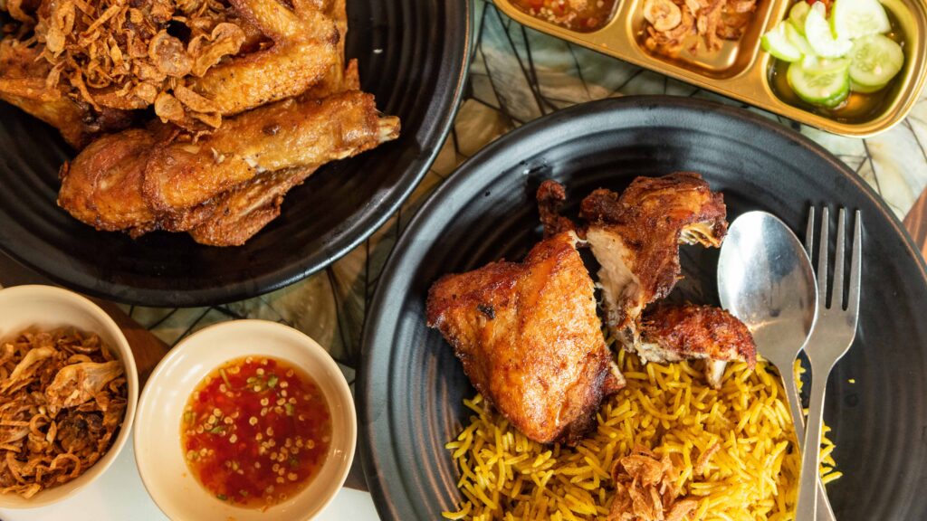 Fried chicken with yellow rice at Kai Tod Decha restaurant in Songkhla, representing the city’s vibrant food culture and UNESCO Creative City of Gastronomy recognition.