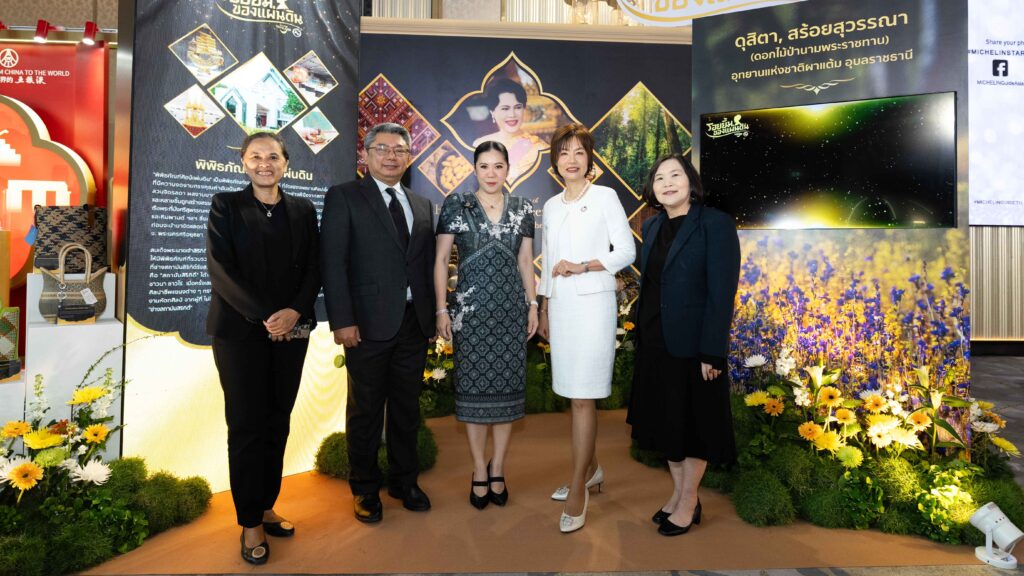 Tourism leaders visit a cultural exhibition booth featuring Royal Project floral displays and Thai craftsmanship during the MICHELIN Guide Thailand 2026 event.