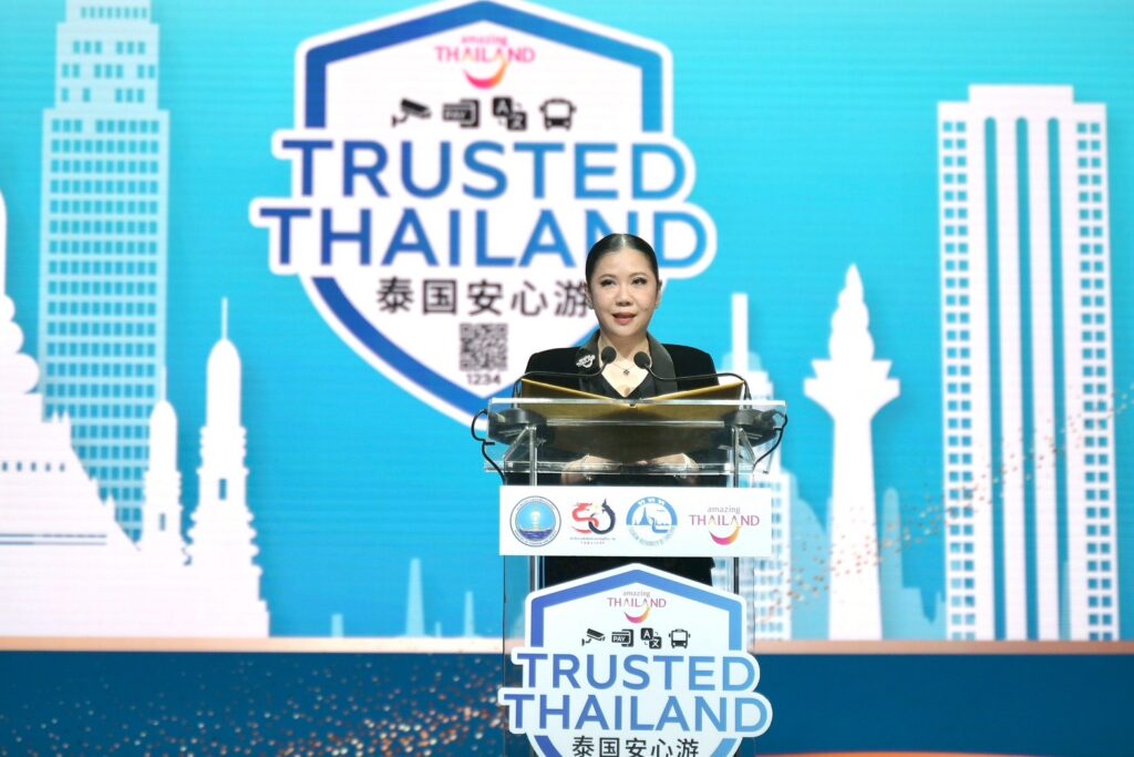 A speaker delivers remarks at the Trusted Thailand launch, standing at the podium with the programme’s safety certification logo displayed behind.
