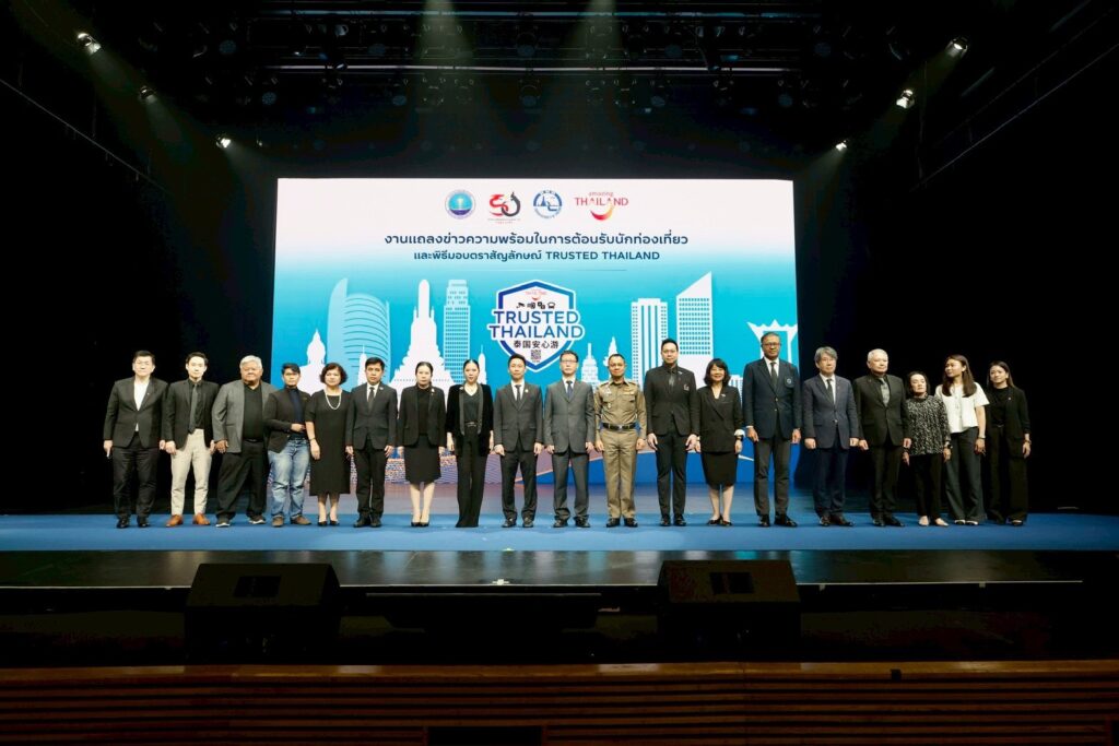 Public and private sector partners stand together on stage during the Trusted Thailand launch ceremony, marking nationwide collaboration to strengthen tourism safety.
