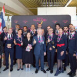 Air France crew and TAT representatives posing together with garlands during the Paris–Phuket inaugural flight welcome at Phuket International Airport.