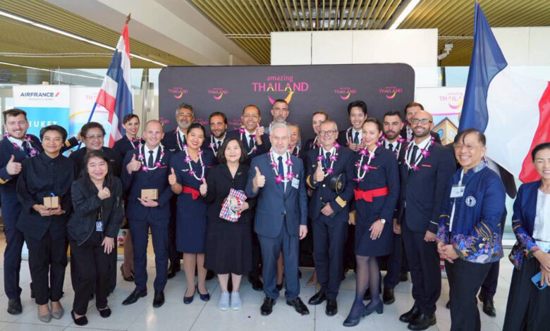 Air France crew and TAT representatives posing together with garlands during the Paris–Phuket inaugural flight welcome at Phuket International Airport.