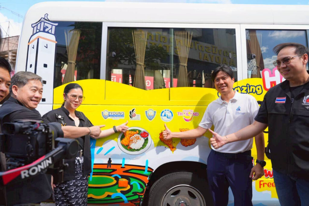 TAT Governor Ms. Thapanee Kiatphaibool and local partners gesture towards the Amazing Hatyai Happy Bus branding during the Smile@Hatyai launch in Hat Yai.