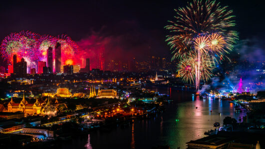 Fireworks illuminate the Bangkok skyline along the Chao Phraya River at night, celebrating the city’s recognition as the world’s most visited destination for international arrivals in 2025.