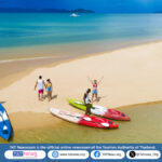 A quiet tropical beach with clear waters and palm trees on Ko Phayam, Ranong.