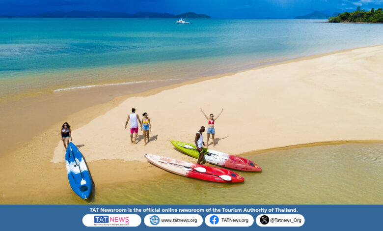 A quiet tropical beach with clear waters and palm trees on Ko Phayam, Ranong.