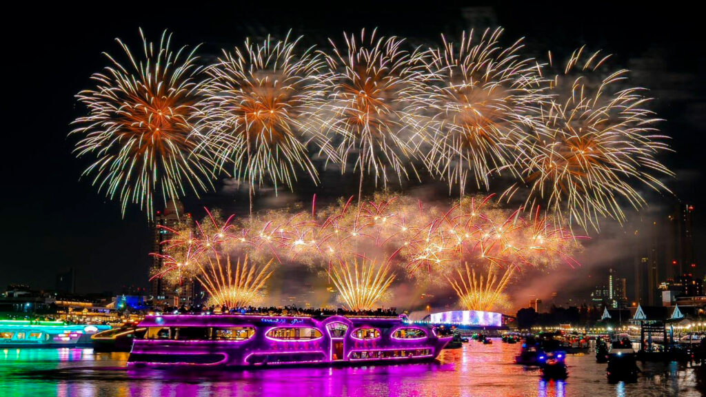 Fireworks burst above illuminated river cruises on the Chao Phraya River as part of the closing night celebrations of Vijit Chao Phraya 2025 in Bangkok.