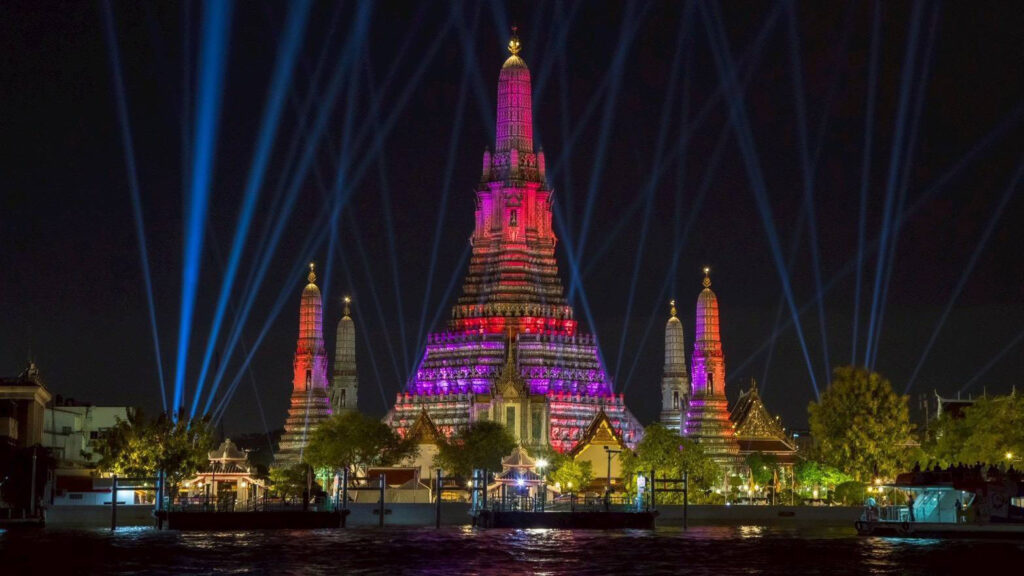Wat Arun Ratchawararam is illuminated with projection mapping and light installations during Vijit Chao Phraya 2025, transforming the riverside landmark into a centrepiece of the festival.