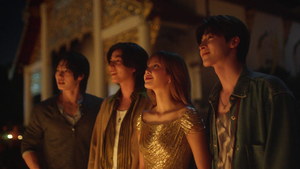 Lalisa “LISA” Manobal with three co-stars admiring candlelit temple surroundings at night
