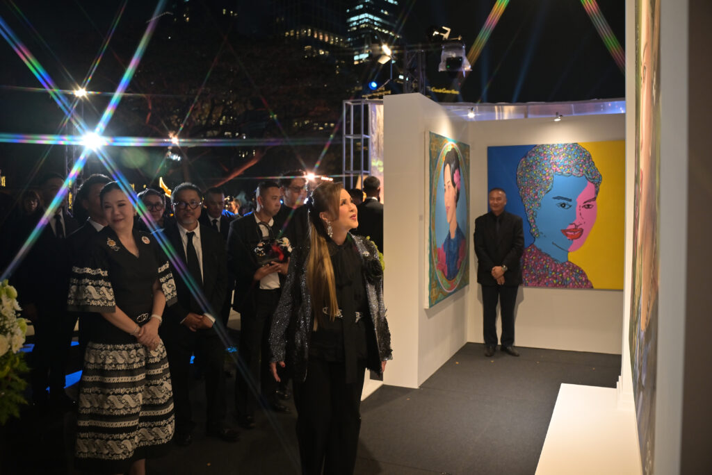HRH Princess Ubolratana tours an art exhibition area at The Night by Amazing Thailand, viewing portrait artworks while accompanied by senior tourism officials and event organisers.