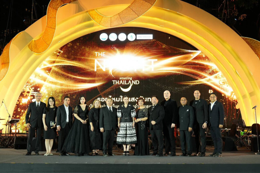 Senior officials and guests stand together on stage beneath the illuminated The Night by Amazing Thailand arch, marking the official opening of the night-time cultural festival.