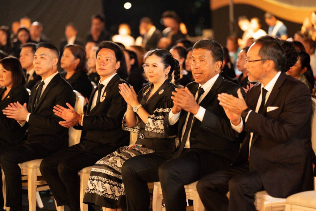 Audience members in formal attire applaud during an evening performance at The Night by Amazing Thailand, reflecting the ceremonial atmosphere of the opening night.