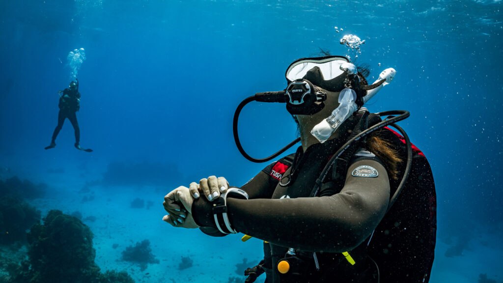 Scuba diver practices underwater breathing and mindfulness during a wellness-oriented dive in Thailand