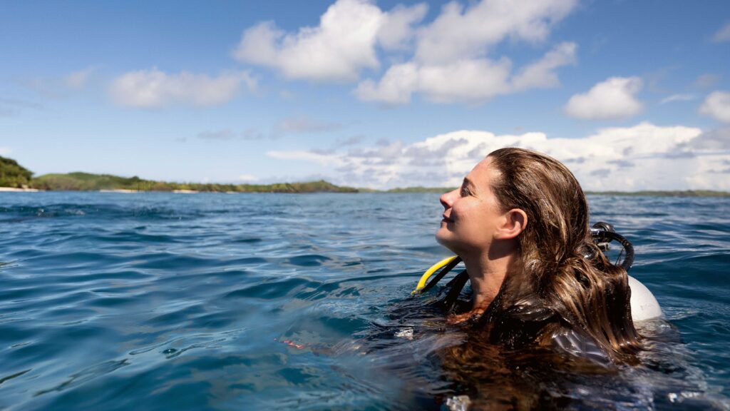 Scuba diver rests at the surface in Thailand, reflecting calm, mindfulness and wellness-led dive tourism experiences