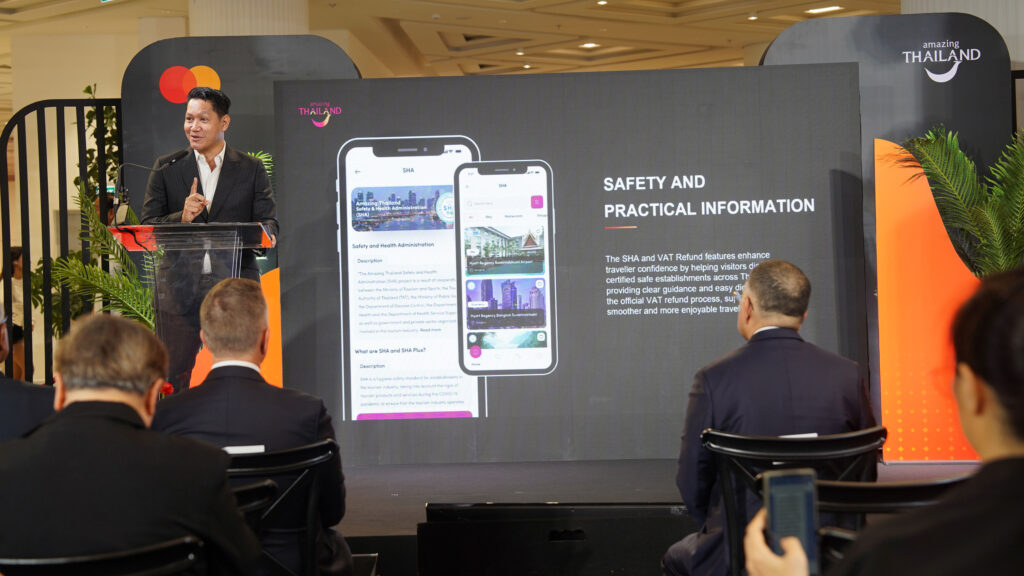 TAT executive presenting enhanced Amazing Thailand app with AI chatbot and safety features during Bangkok launch event
