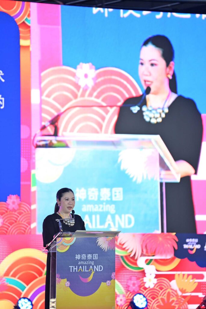 Ms. Thapanee Kiatphaibool delivering opening remarks on stage