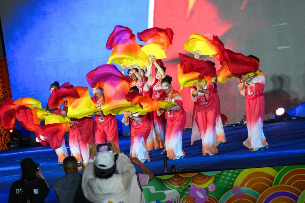 Traditional dance performance with colourful fans on stage