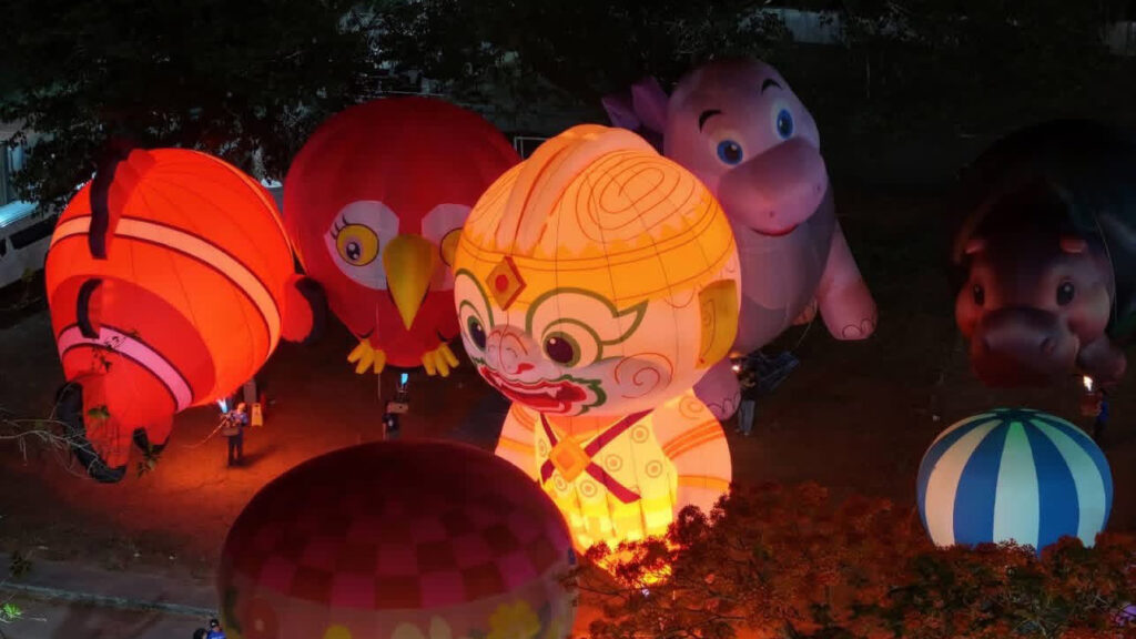 Colourful illuminated hot air balloon installations and cultural figures at Smile @Pattani festival night event