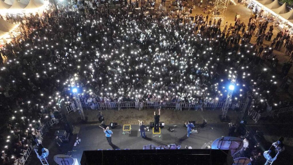 Large crowd enjoying live concert at Smile @Pattani festival with audience lights creating vibrant atmosphere