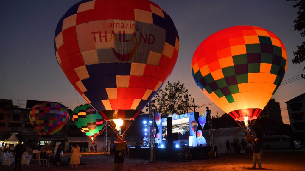 Hot air balloons glowing at sunset with Amazing Thailand branding at Smile @Pattani festival in Pattani