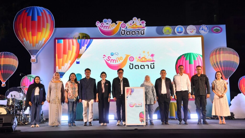 Smile @Pattani festival opening ceremony with TAT officials on stage and colourful hot air balloon backdrop in southern Thailand
