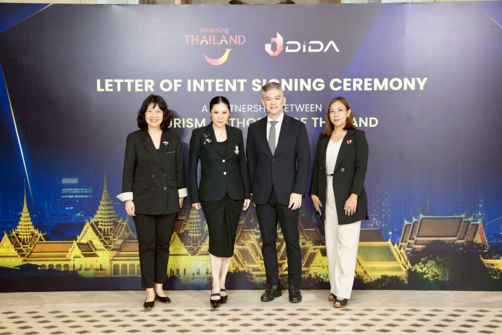 2. TAT Governor and Dida CEO posing at Trusted Thailand partnership signing backdrop