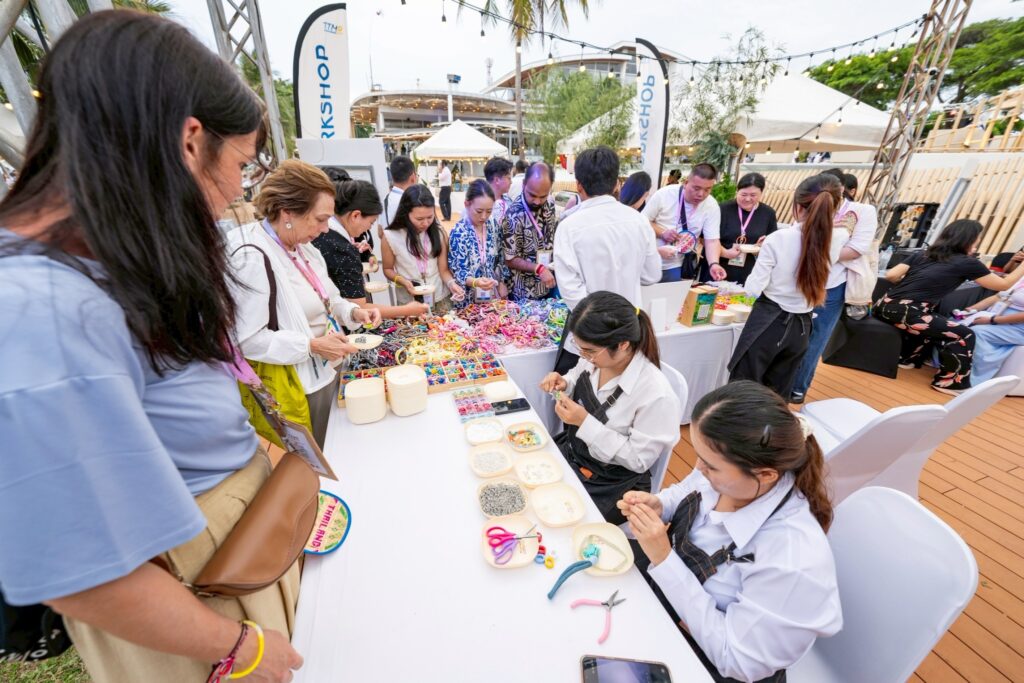 TTM+ 2026 guests join a hands-on craft activity during the beachfront networking reception in Pattaya.