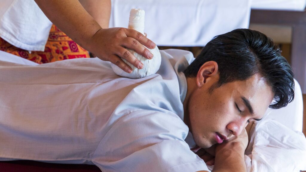 Thai herbal compress massage at a Chiang Mai wellness retreat, reflecting Thailand’s Healing is the New Luxury concept.
