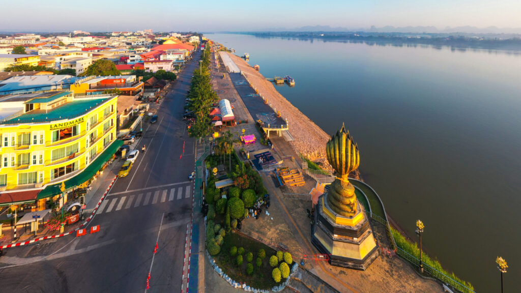 Golden morning view of the Mekong River and Nakhon Phanom riverfront, highlighting slow travel and peaceful Isaan scenery.